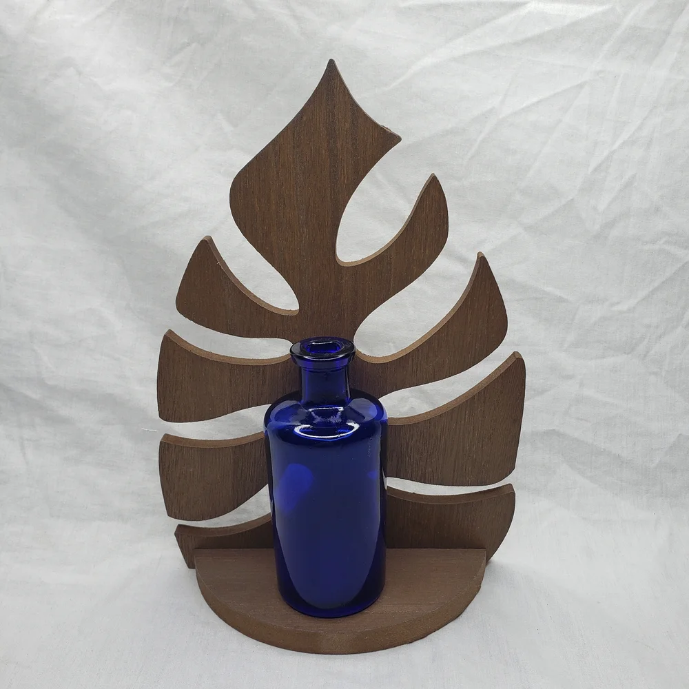 Wood Monstera Leaf Shelf With Blue Glass Vase